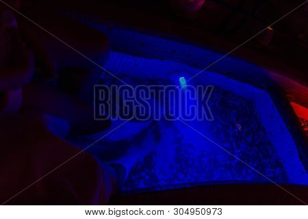 Woman And Man Legs In Kneipp Walk In Blue Cold Water In Wellness