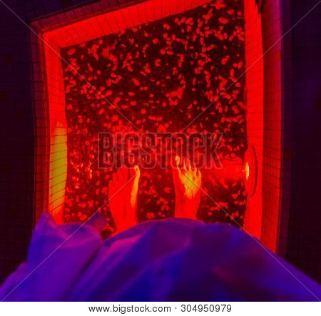 Man Stand In Kneipp Walk On Red Warm Water, Wellness