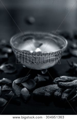 Milk Face Pack On Black Shiny Surface Consisting Of Raw Milk,turmeric Or Haldi And Badam In A Glass