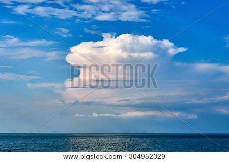 Cloud Over The Sea In The Form Of A Huge Iceberg.