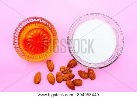 Milk And Almond Face Pack On Isolated On Pink Surface I.e. Raw Milk,almond,honey Well Mixed In A Gla