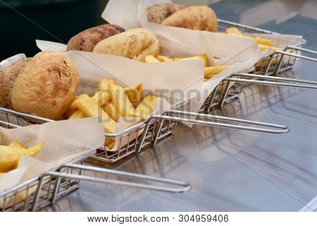 Cooking French Fries. Closeup View Of Making French Fries Deep Frying In Fast Food. The Concept Of F