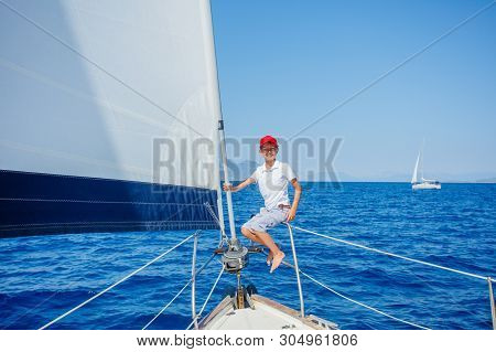 Little Boy On Board Of Sailing Yacht On Summer Cruise. Travel Adventure, Yachting With Child On Fami