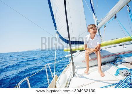 Little Boy On Board Of Sailing Yacht On Summer Cruise. Travel Adventure, Yachting With Child On Fami