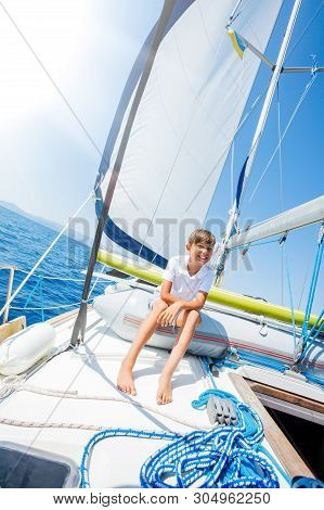 Little Boy On Board Of Sailing Yacht On Summer Cruise. Travel Adventure, Yachting With Child On Fami