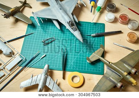 Top View On Plastic Model Scale With Accessories On  Green Pad On  Wooden Table
