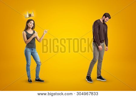 Young Happy Brunette Girl In Casual Clothes With A Golden Crown Above And A Sad Man In Casual Clothe