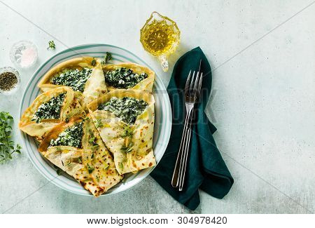 Traditional Italian Pancakes Crepes With Spinach And Ricotta On A Served Table. Healthy Vegetarian D