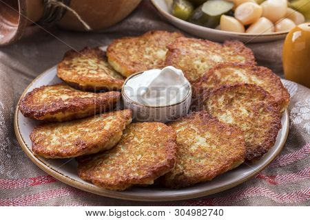 Potato Pancakes With Sour Cream. The Naitonal Dish Of Belarus.  Draniki. Closeup