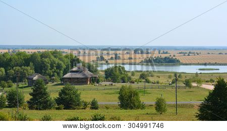 Summer Rural Landscape With Old Cottage And Lake In Belarus.