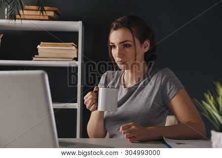 Tired Woman Workiing At Night In Office. Overtime Working Concept.