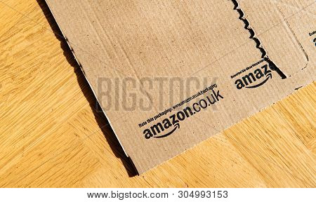 Paris, France - Feb 21, 2018: Amazon.co.uk Cardboard Open Package On The Wooden Parquet Floor