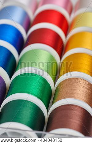 Background From Spools With Multicolored Sewing Threads