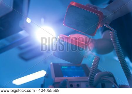 The Doctor Is Giving A Defibrillators To Save The Patient\'s Life In The Hospital. Cpr. Using A Defi