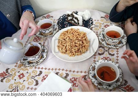 People Eating Chak-chak Dessert With Tea
