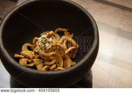 Bowl With Delicious Pork Cracklings On The Table