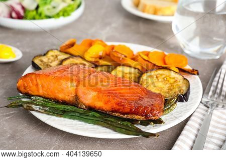 Delicious Cooked Salmon And Vegetables On Grey Table, Closeup. Healthy Meals From Air Fryer