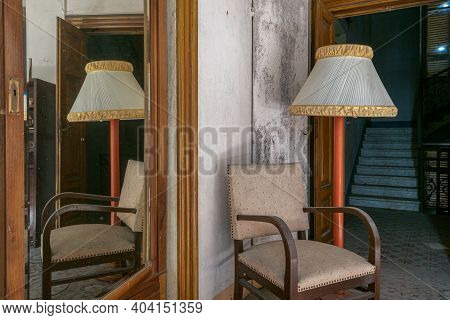 Italy, 20 January 2021. Vintage Chair And Lamp From A Disused Office In An Abandoned House. Urbex