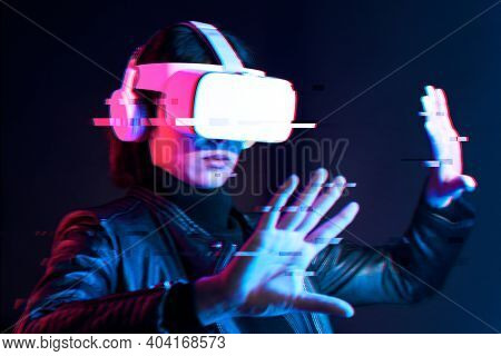 Woman using virtual reality gadget for entertainment