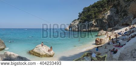 Gulf Of Orosei, Sardinia, Italy, September 17, 2020: Panoramic View Of Cala Goloritze Beach With Tou