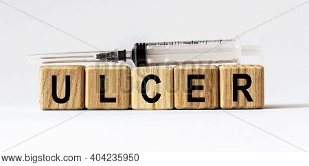 Text Ulcer Made From Wooden Cubes. White Background
