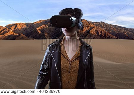 Woman Wearing A Virtual Reality Headset In A Simulated Hiking Experience Through The Desert.  Vr Tou