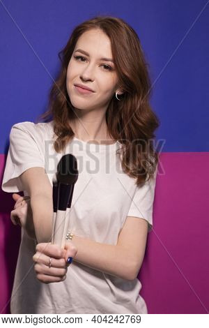 Charming Brunette Woman In White T-shirt With Makeup Brushes Isolated On Colorful Blue And Pink Back