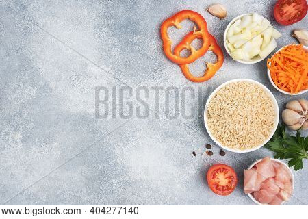 Raw Ingredients For Cooking Pilaf, Brown Rice And Chicken Fillet, Grated Carrots And Chopped Onions,