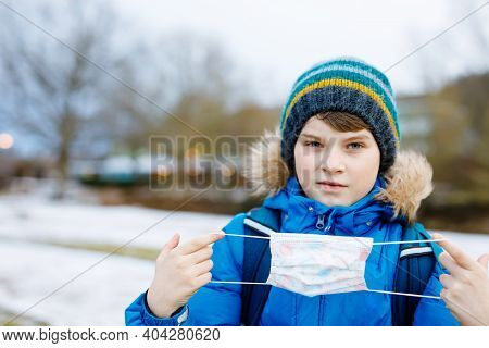 Kid Boy Wearing Ffp Medical Mask On The Way To School. Child Backpack Satchel. Schoolkid On Cold Aut