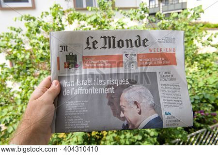 Paris, France - May 12, 2018: Pov Male Hand Holding Le Monde French Newspaper With Donald Trump Us P