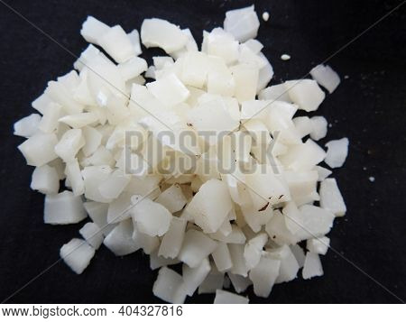 Small Size Sliced Or Cut Piece Of Dry Copra With Cup And Bowl Isolated On Black Background