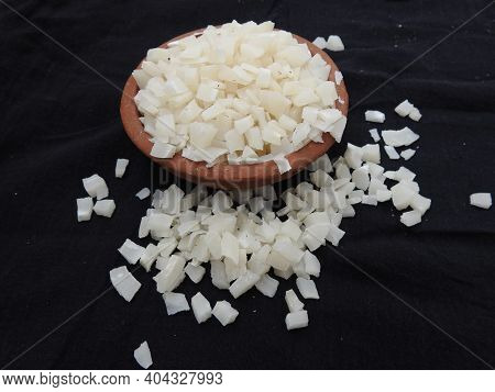 Small Size Sliced Or Cut Piece Of Dry Copra With Cup And Bowl Isolated On Black Background