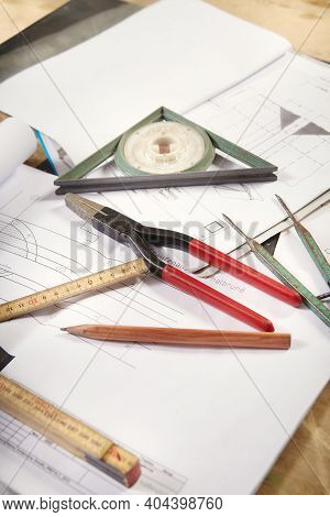 Detail Of Tools, Folding Meter, Inclinometer And Drawing On Table