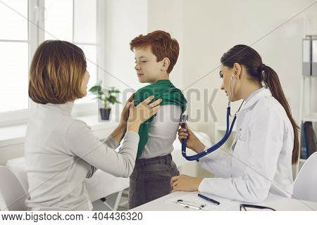Woman Doctor Pediatrician Examining Little Smiling Boy With Stethoscope