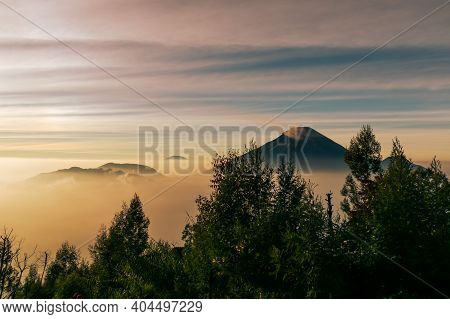 View Of The Sindoro Mountains With A Sea Of ​​clouds In Central Java, Indonesia From The Top Early I