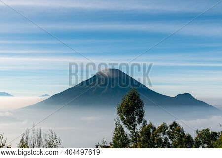 View Of The Sindoro Mountains With A Sea Of ​​clouds In Central Java, Indonesia From The Top Early I