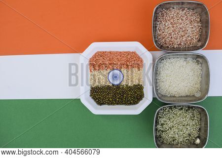 Three Colors Of Rice Resembling Indian Tri Coloured India Flag With Ashok Chakra. Background To Writ