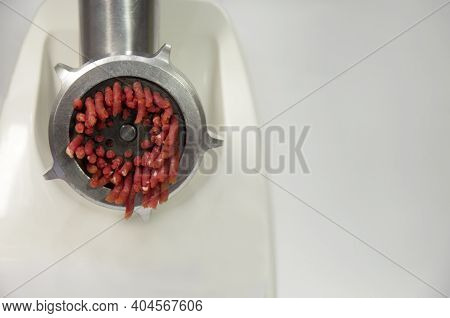 Electric Meat Grinder Grinds Raw Red Meat Into Mince. High Quality Photo
