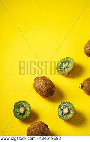 Kiwi Fruits Half Sliced On Yellow Background, Top View Flat Lay
