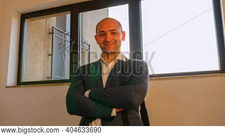 Close Up Of Cheerful Boss Looking At Camera And Smiling Standing On Stairs In Corporate Building. Go