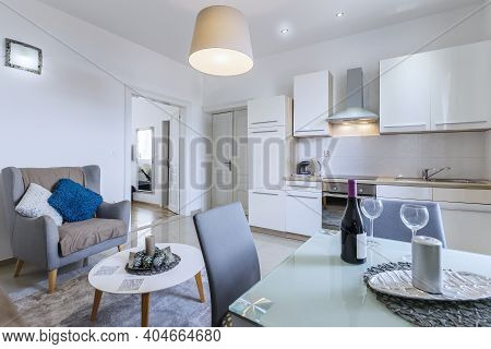 Modern Kitchen Interior With Table And Wine