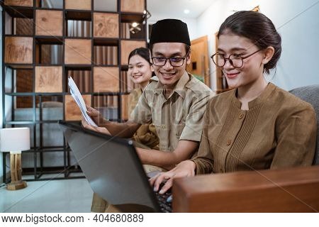 Some Teachers In Civil Servant Uniforms Work On A Computer Laptop And Paperwork
