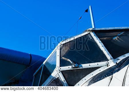 White Capit Piston Plane, Engine And Propeller On Blue Sky Background.