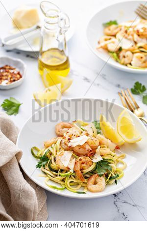 Shrimp And Zucchini Noodles Or Zoodles Pasta With Parmesan And Chili Flakes With Lemon In White Bowl
