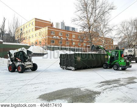 Moscow. Russia. January 15, 2021. Small Front-end Loaders Clear Snow From The Street And Load Into A