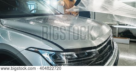 Process Of Installing Of Paint Protection Film Or Ppf On New Car In Professional Auto Detailing Cent