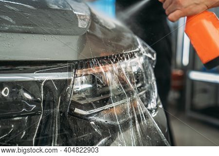 Process Of Installing Of Paint Protection Film Or Ppf On New Car In Professional Auto Detailing Cent