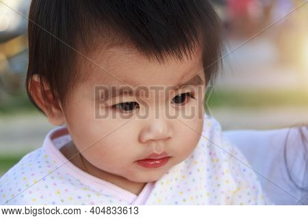 Close Up Portrait Little Girl. Cute Adorable Asian Little Girl Play In Park With Sun Ray Background.