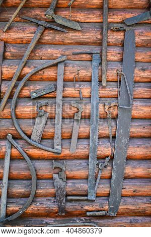 Ancient Wooden Etnographic Barn Wall With Tools. Wooden Wall. Work Tools