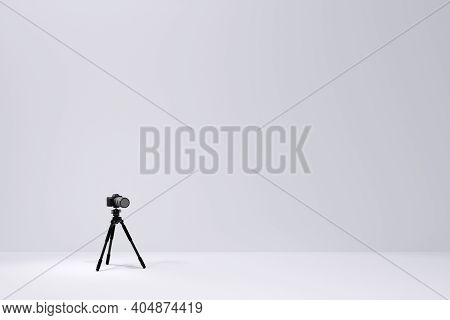 Photo And Video Tripod With Nonexistent Dslr Camera On The White Backgound
